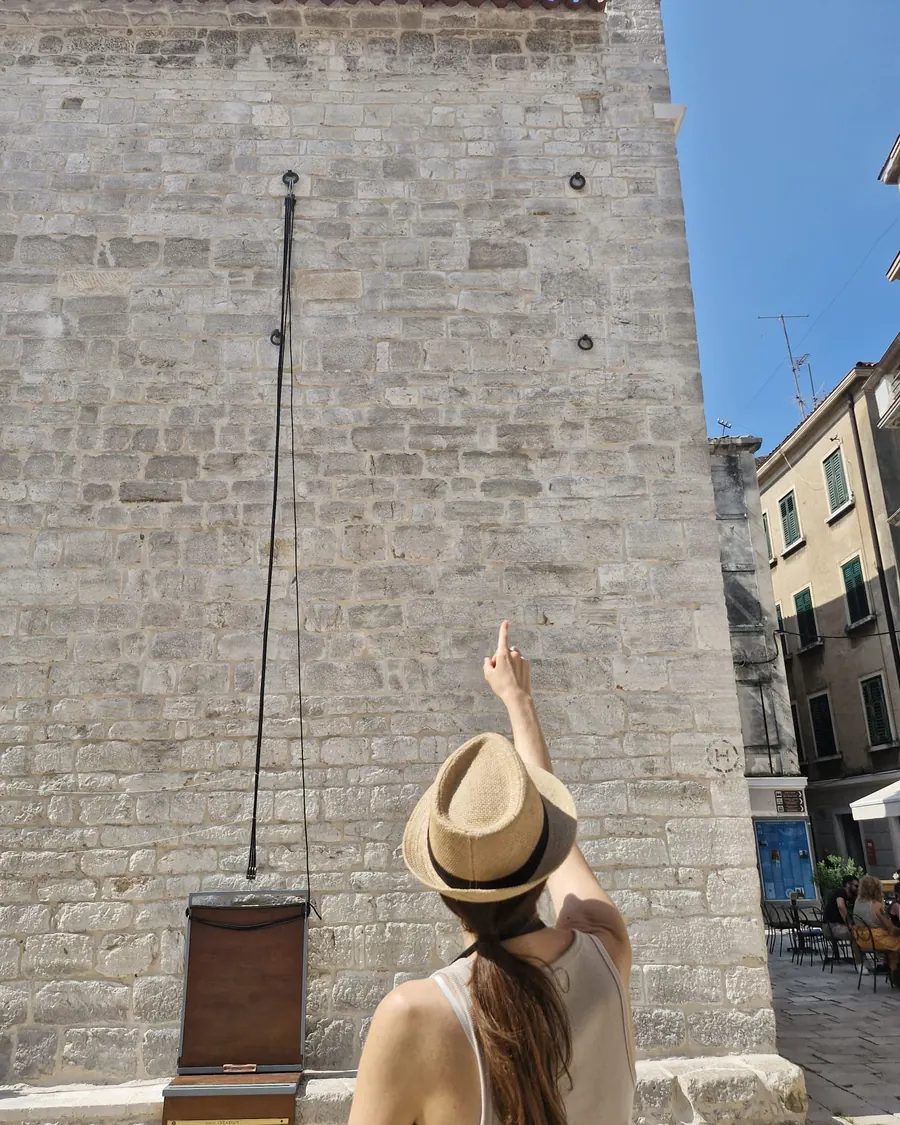 Ivana pointing out details on a bell tower during the history and coffee walking tour of Šibenik