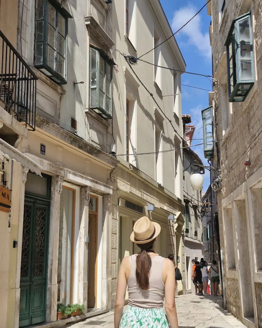 Ivana in a narrow stone street on a private history tour of Šibenik's Old Town