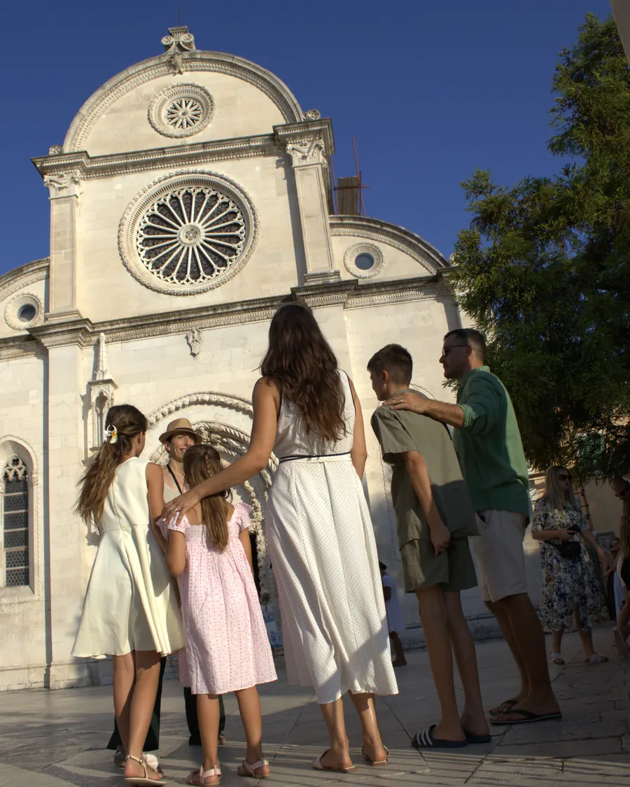 A family with Ivana outside the Cathedral of St. James on a Šibenik family walking tour