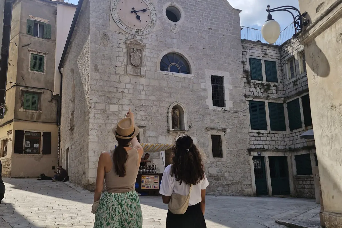 Ivana with a guest on a historic square during a private Šibenik Old Town walking tour