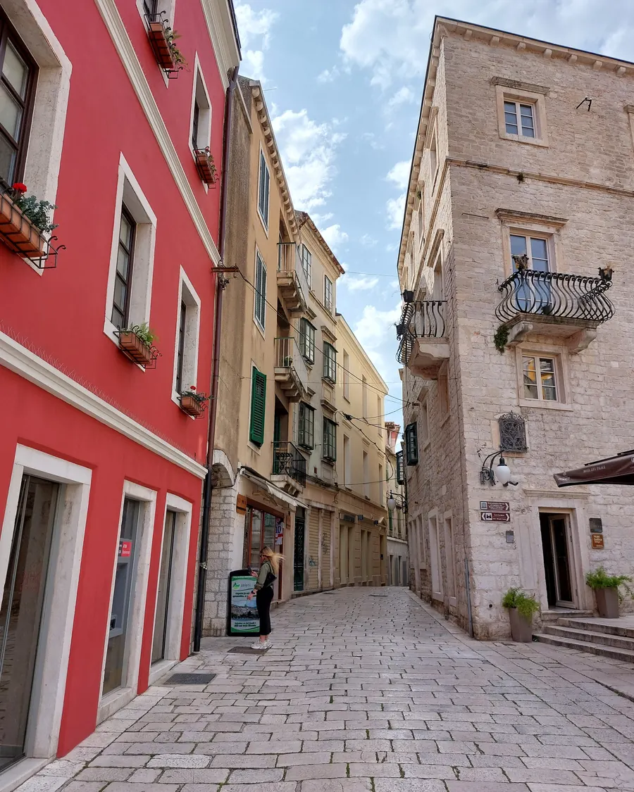 A red facade on a cobbled street in Šibenik's Old Town, seen on the history and Homeland War tour