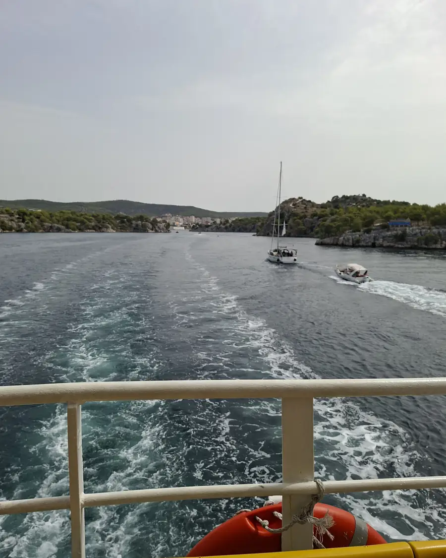 The boat wake and moored sailboats in the Šibenik archipelago on the way to Zlarin