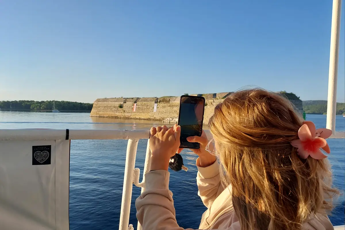 A guest photographing the Šibenik archipelago from the boat on the way to Zlarin