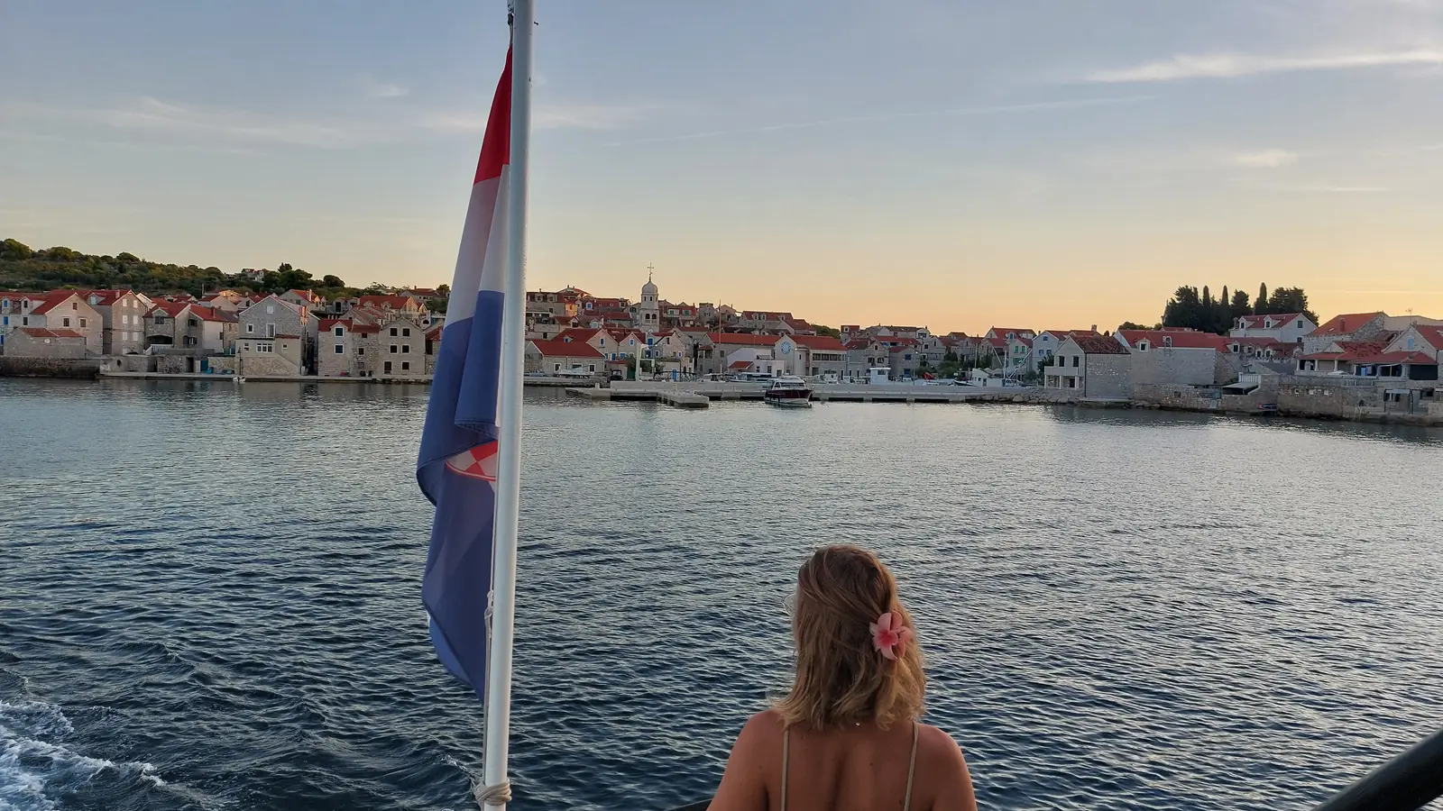 Arriving at Zlarin by the public boat line, the island village ahead at golden hour